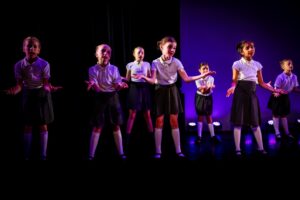 musical theatre children performing a scene from Matilda